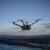 Dron DJI Matrice 4D w locie nad górami o zmierzchu