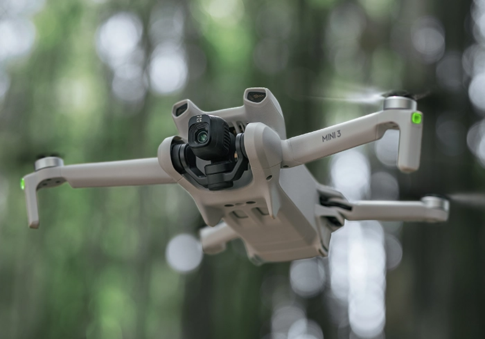 Dron DJI Mini 3 z kontrolerem RC w locie od dołu