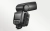 Lampa błyskowa Godox TT685IIO z otwartą komorą baterii i odchyloną głowicą