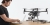 Technik przy laptopie obok dronów DJI Matrice i Mavic Enterprise podczas diagnostyki serwisowej