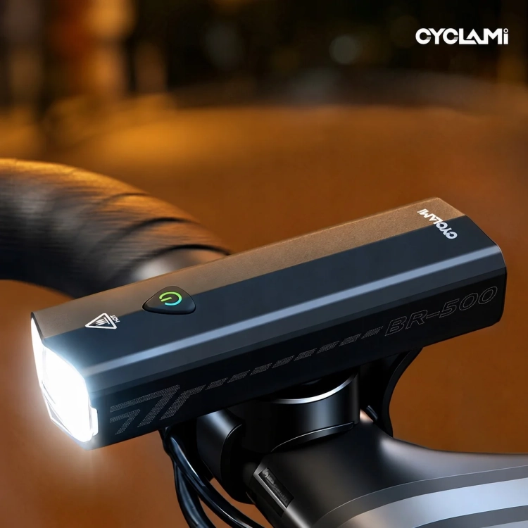 Włączona lampka CYCLAMI BR-500 na kierownicy roweru