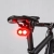 Włączona lampka CYCLAMI CY200 pod siodełkiem roweru szosowego