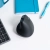 Mysz JLab JBuds Ergonomic na biurku z notesem i długopisem