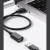 Przedłużacz UGREEN US129 wpięty w laptop, obok wtyk urządzenia USB